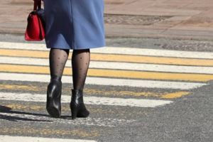 a woman about to enter a crosswalk