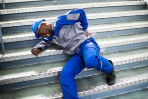 African-American worker lying on steps