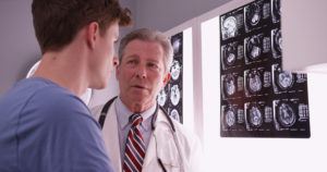 doctor-going-over-brain-x-rays-with-a-patient