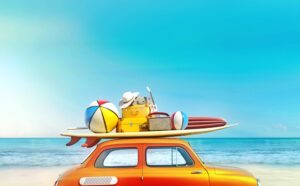 car driving to beach with surf board beach balls