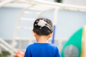 child with a bandage on his head